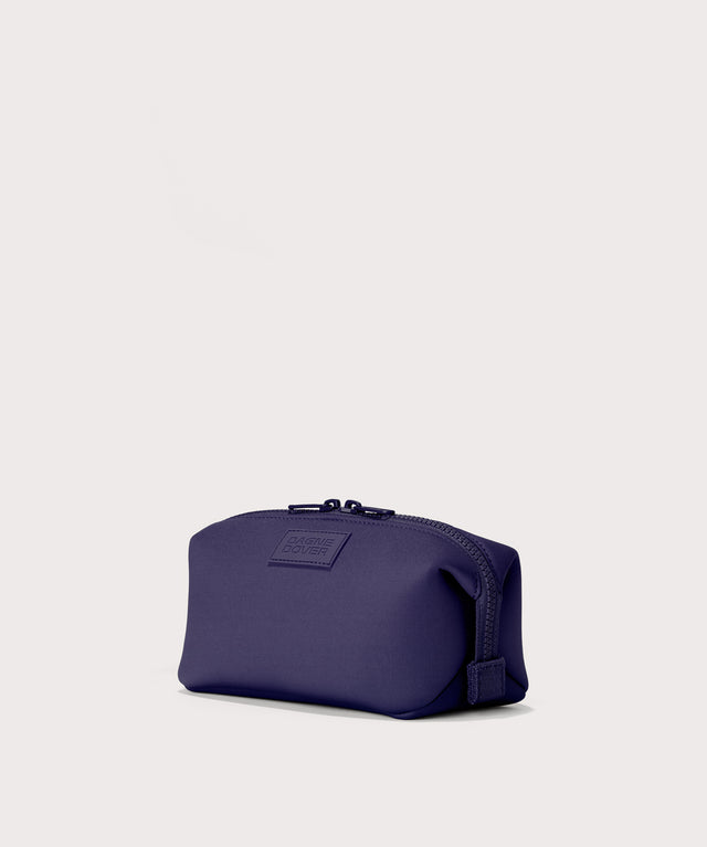 Hunter small toiletry bag in a jewel-toned, deep blue with strong purple undertones. Angle view. 
