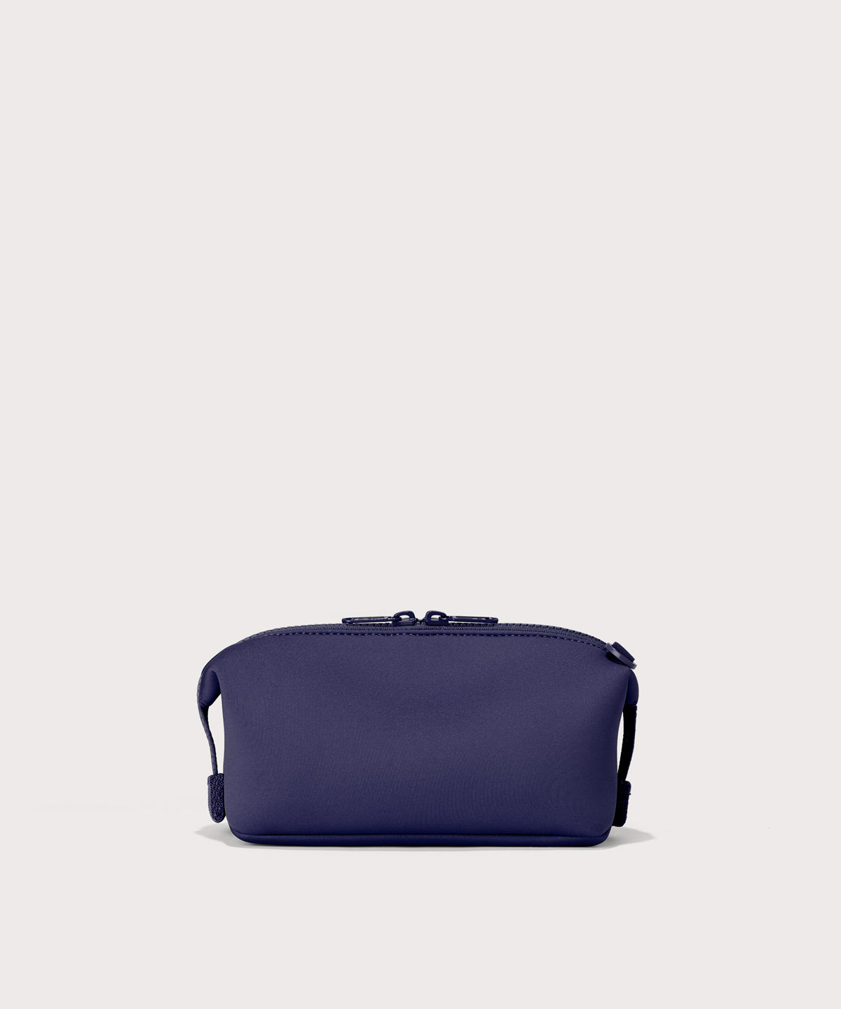 Hunter small toiletry bag in a jewel-toned, deep blue with strong purple undertones. Back view. 
