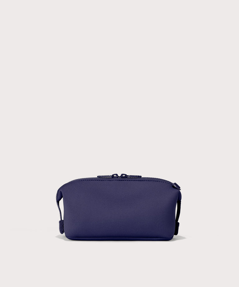 Hunter small toiletry bag in a jewel-toned, deep blue with strong purple undertones. Back view. 
