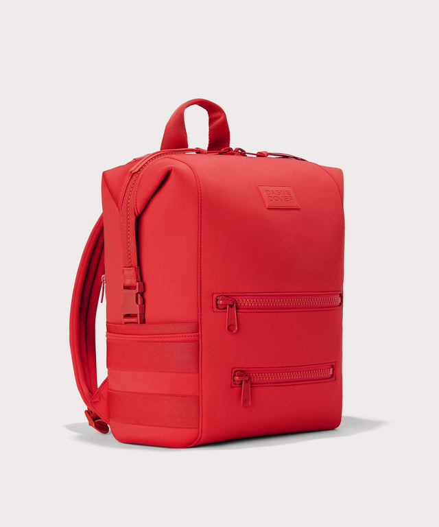 Dagne Dover Large Indi Diaper Backpack in a fiery, saturated red leaning toward orange seen from an angle.