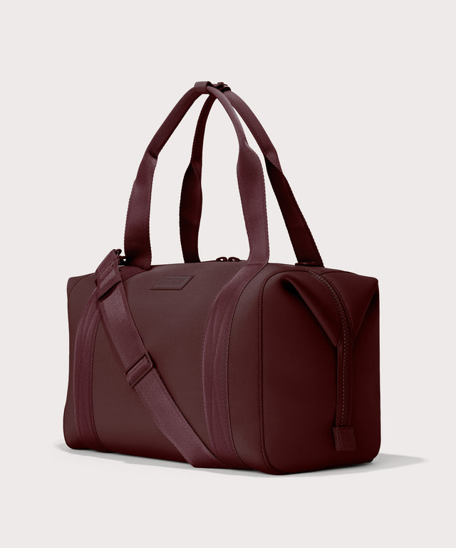 Dagne Dover Large Landon Carryall in a deep brown with purple undertones seen from an angle.