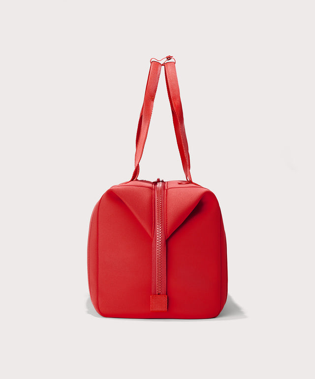 Dagne Dover Large Landon Carryall in a fiery, saturated red leaning toward orange seen from the side.