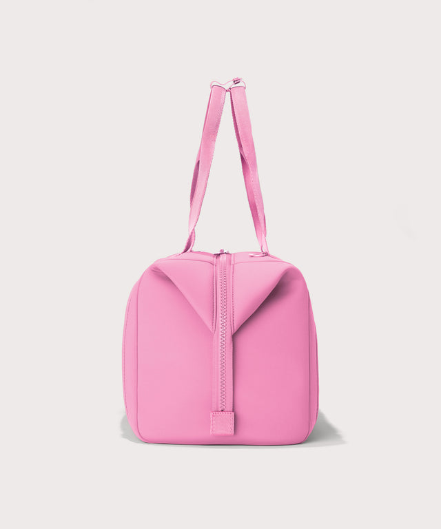 Dagne Dover Large Landon Carryall in a true bubble gum pink seen from the side.