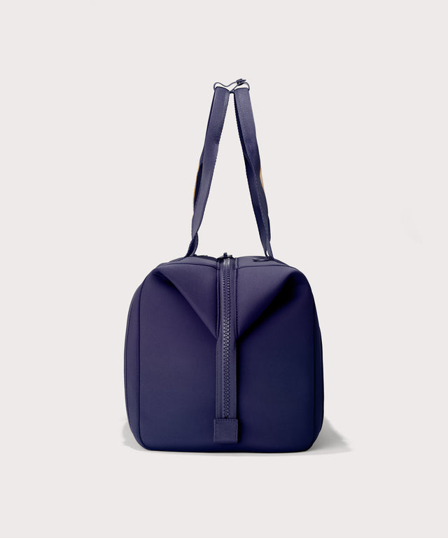Large Landon Carryall in a jewel-toned, deep blue with strong purple undertones, side view
