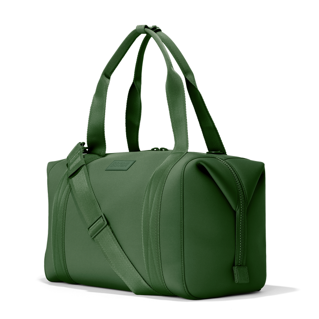 Dagne Dover large Landon Carryall in a rich, classic forest green, seen from an angle.
