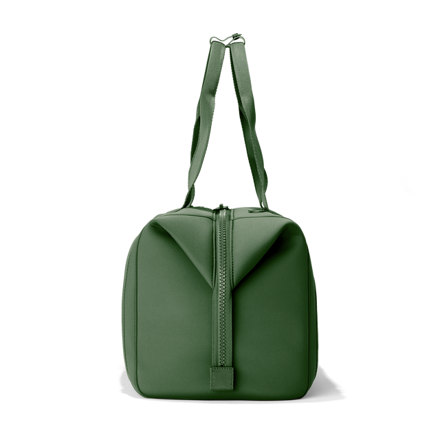 Dagne Dover large Landon Carryall in a rich, classic forest green, seen from the side.
