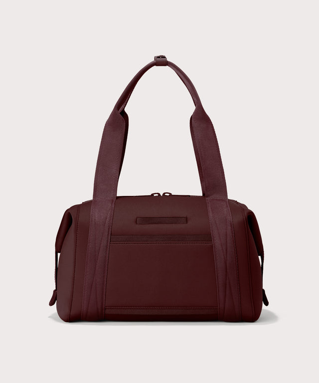 Dagne Dover Medium Landon Carryall in a deep brown with purple undertones seen from the back.