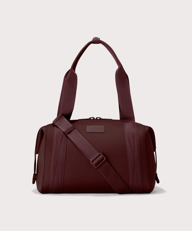 Dagne Dover Medium Landon Carryall in a deep brown with purple undertones.