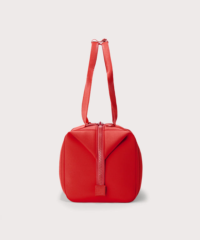 Dagne Dover Medium Landon Carryall in a fiery, saturated red leaning toward orange seen from the side.