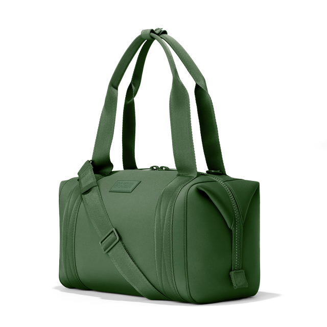 Dagne Dover medium Landon Carryall in a rich, classic forest green, seen from an angle.
