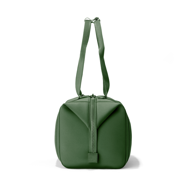 Dagne Dover medium Landon Carryall in a rich, classic forest green, seen from the side.
