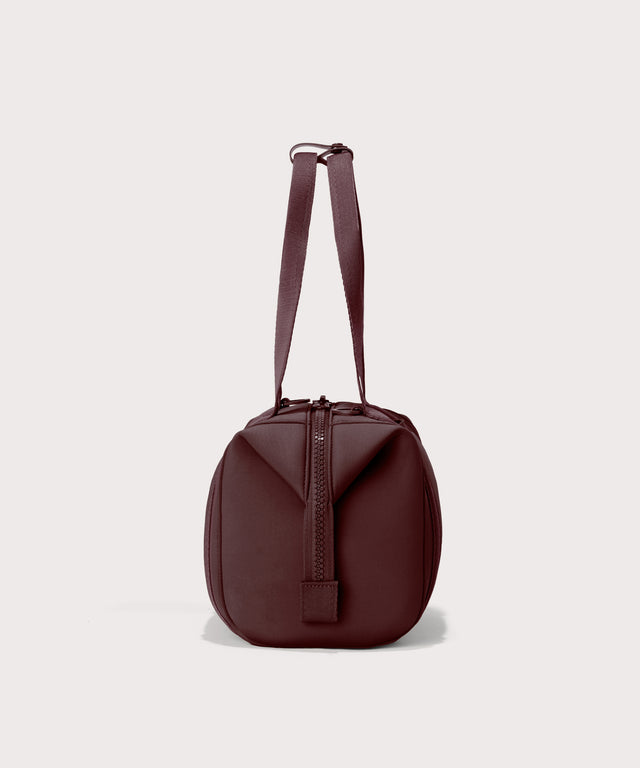 Dagne Dover Small Landon Carryall in a deep brown with purple undertones seen from the side.