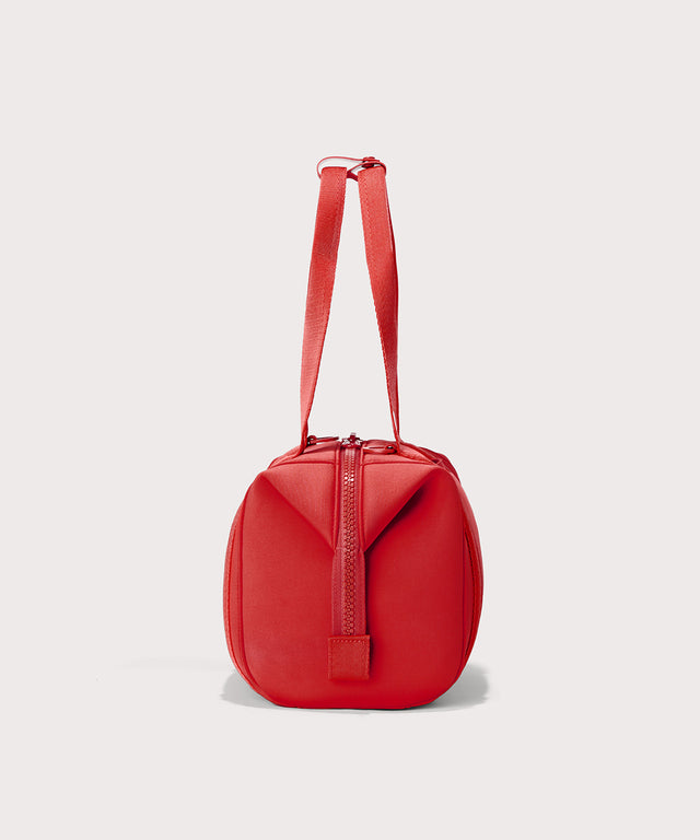 Dagne Dover Small Landon Carryall in a fiery, saturated red leaning toward orange seen from the side.