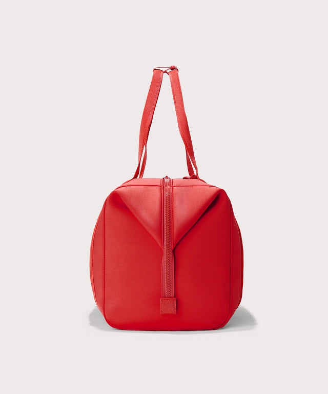 Dagne Dover Extra Large Landon Carryall in a fiery, saturated red leaning toward orange seen from the side.
