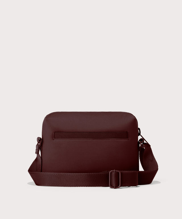 Dagne Dover Micah Crossbody in a deep brown with purple undertones seen from the back.