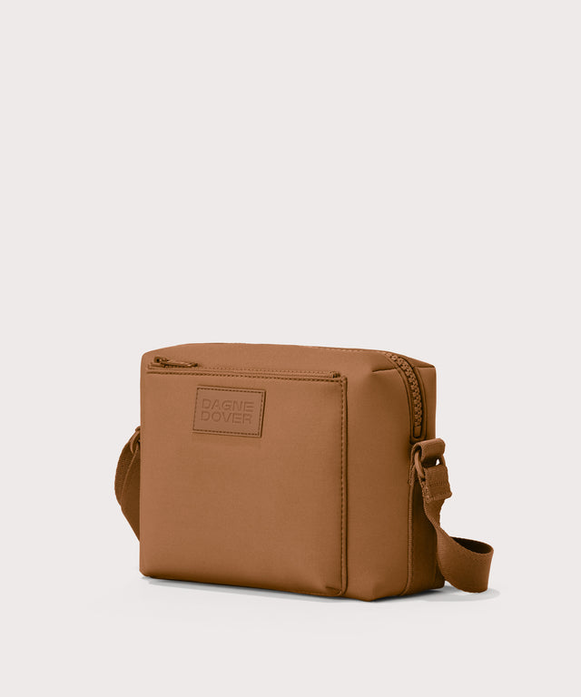 Micah crossbody bag in a saturated, warm medium-brown with burnt orange undertones, side angle view
