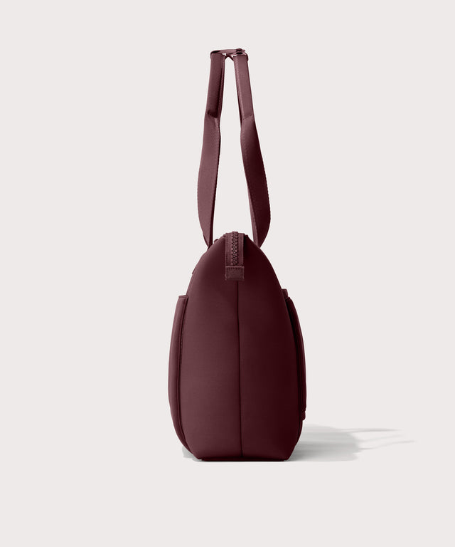 Tote  bag in a deep brown with purple undertones reminiscent of maroon seen from the side view.