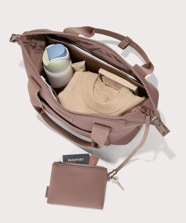 Tote  in a pink seen from the top down view showing interior mesh pouch.
