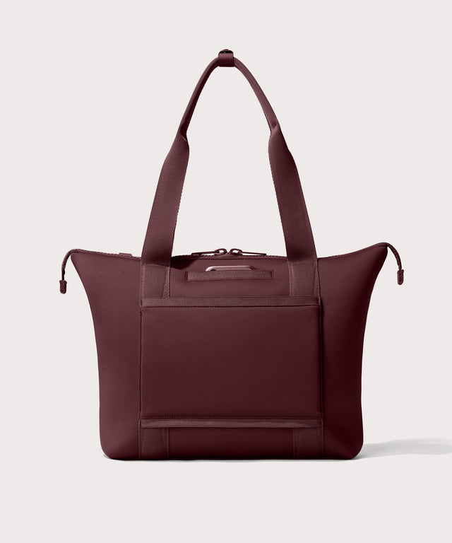 Tote  bag in a  deep brown with purple undertones reminiscent of maroon seen from the back view showing phone pocket.
