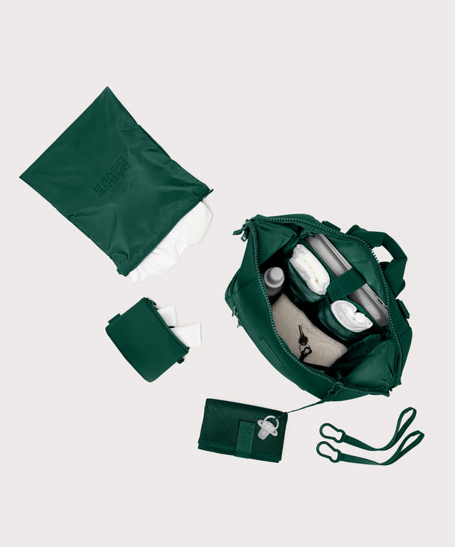 Large Indi backpack in a saturated, jewel-toned deep green with bold blue undertones. top down view. 
