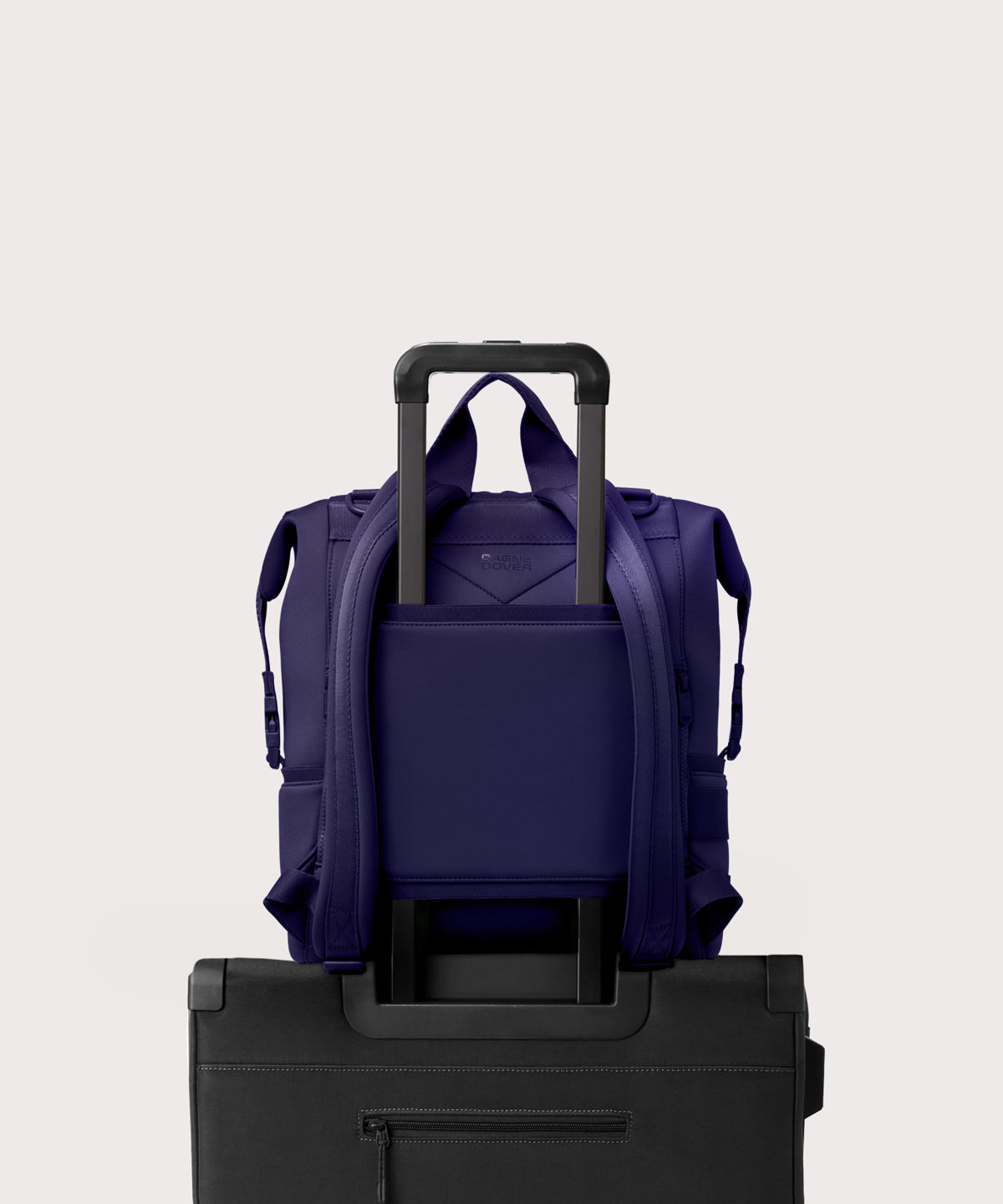 Large Indi backpack in a jewel-toned, deep blue with strong purple undertones. displaying luggage sleeve
