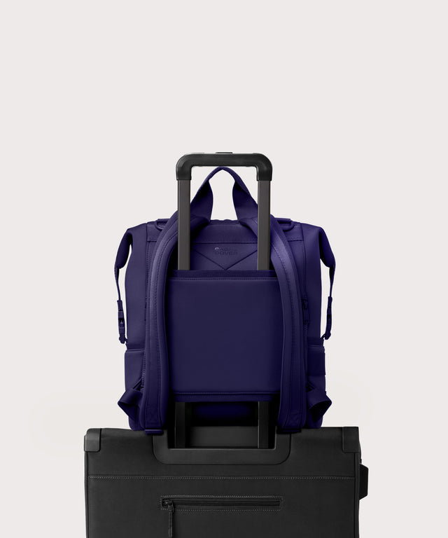 Large Indi backpack in a jewel-toned, deep blue with strong purple undertones. displaying luggage sleeve
