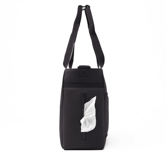 Dagne Dover large Wade Diaper Tote in black seen from the side, with a wet wipe poking out of the slip pocket.