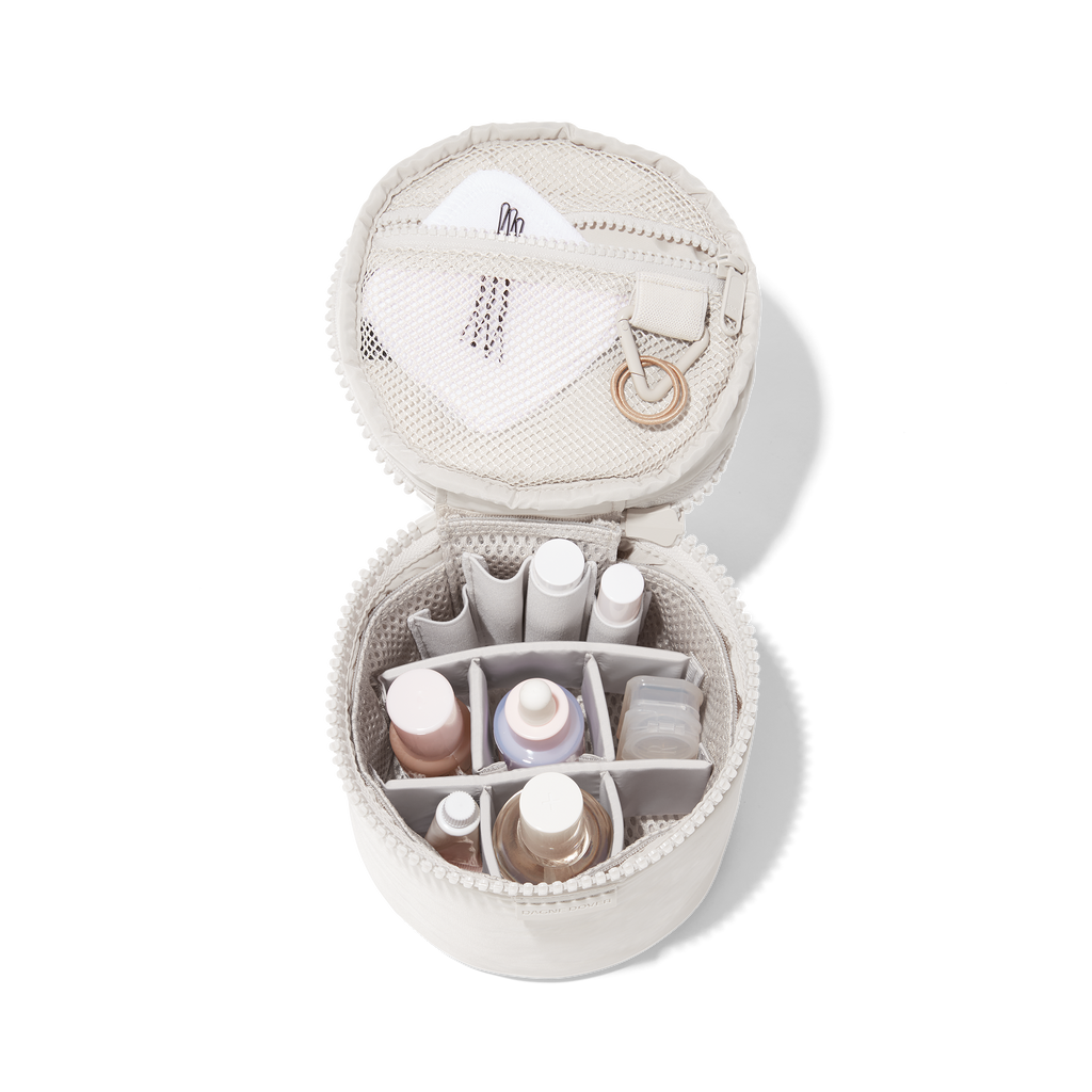  - Dagne Dover small Mila Toiletry Pouch in white unzipped filled with toiletry products.