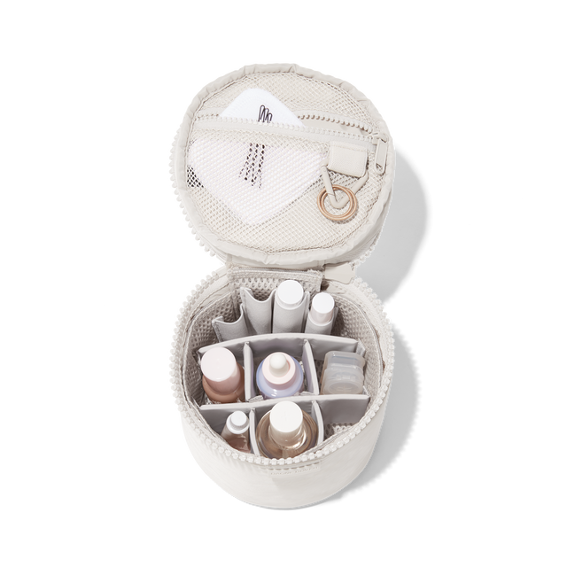 hover - Dagne Dover small Mila Toiletry Pouch in white unzipped filled with toiletry products.