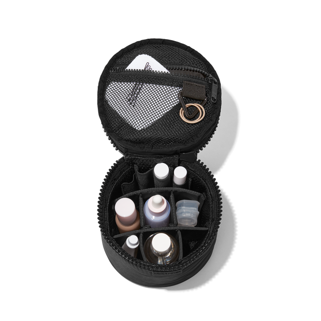 hover - Dagne Dover small Mila Toiletry Pouch in black unzipped filled with toiletry products.
