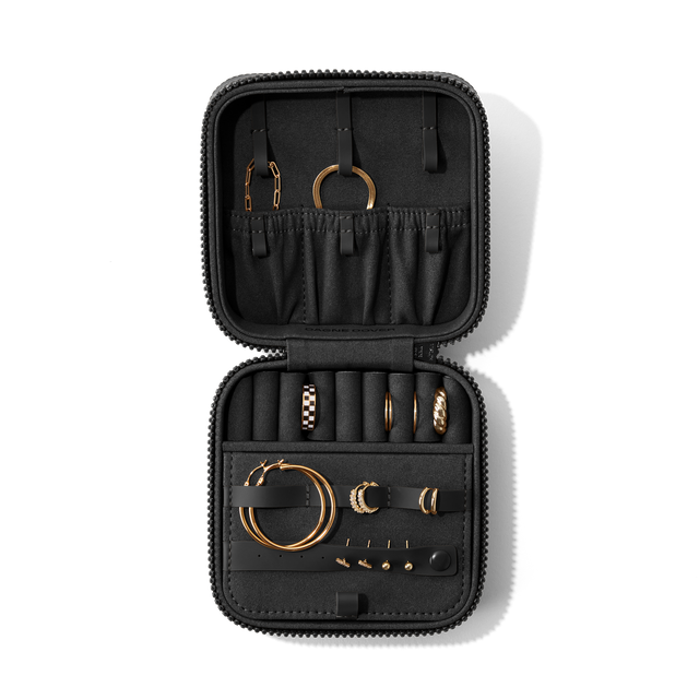 Dagne Dover Large Frankie Jewelry Case in black, seen open from above with jewelry inside and the interior compartment closed. hover