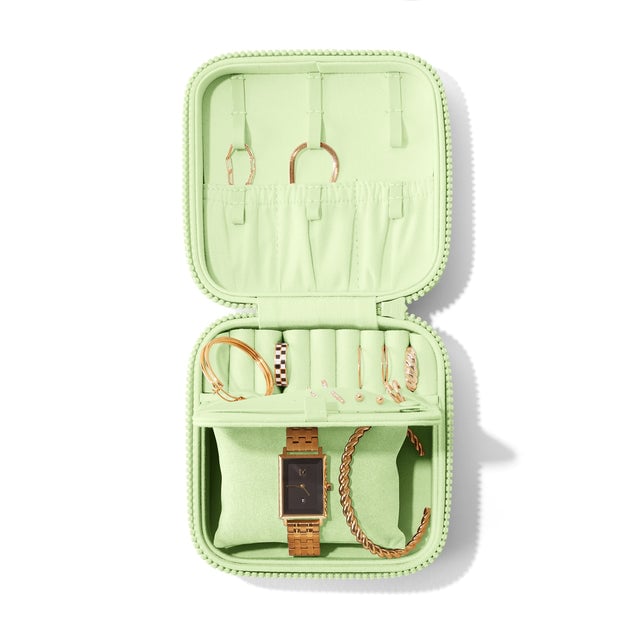 Dagne Dover Large Frankie Jewelry Case in a matcha green, seen open from above with jewelry inside the interior compartment.