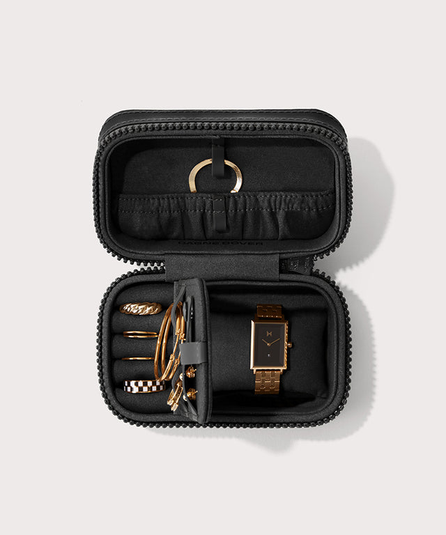Dagne Dover small Frankie Jewelry Case in black, seen open from above with jewelry inside the interior compartment.