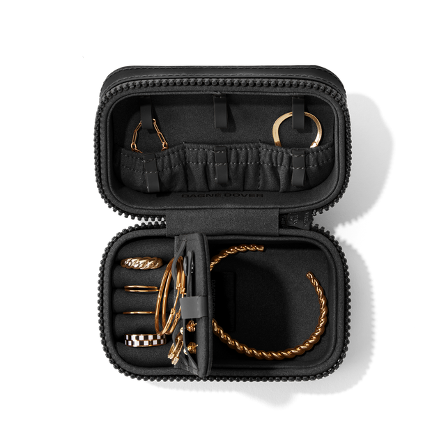 Dagne Dover Small Frankie Jewelry Case in black, seen open from above with jewelry inside the interior compartment.