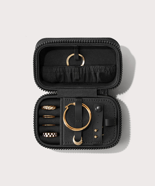 Dagne Dover small Frankie Jewelry Case in black, seen open from above with jewelry inside the interior compartment.