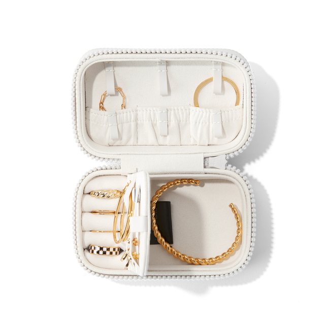 Dagne Dover Small Frankie Jewelry Case in white, seen open from above with jewelry inside the interior compartment.