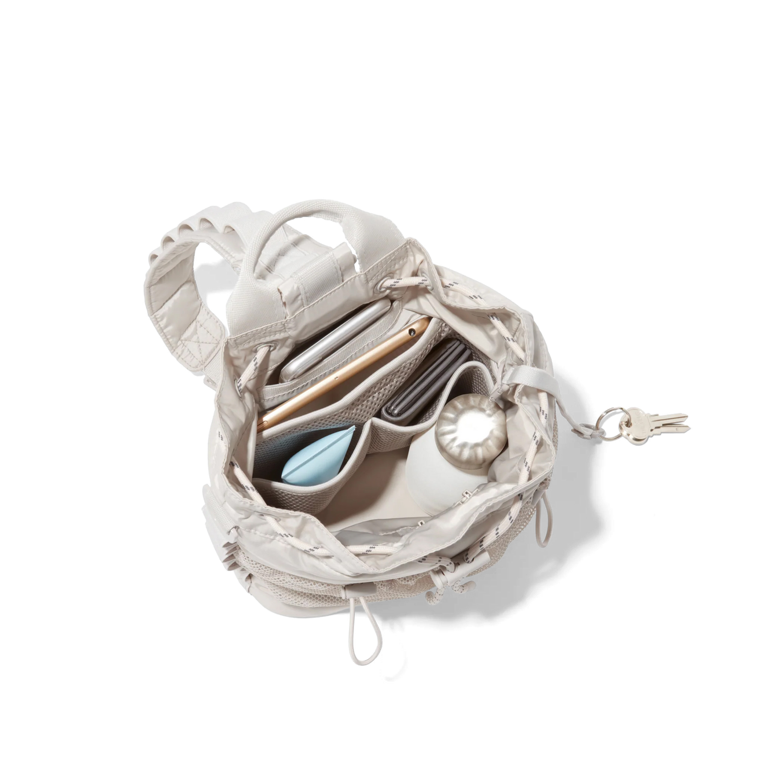 hover - Dagne Dover Nova Sling Bag in white opened, revealing the interior phone pocket and interior airmesh pockets.