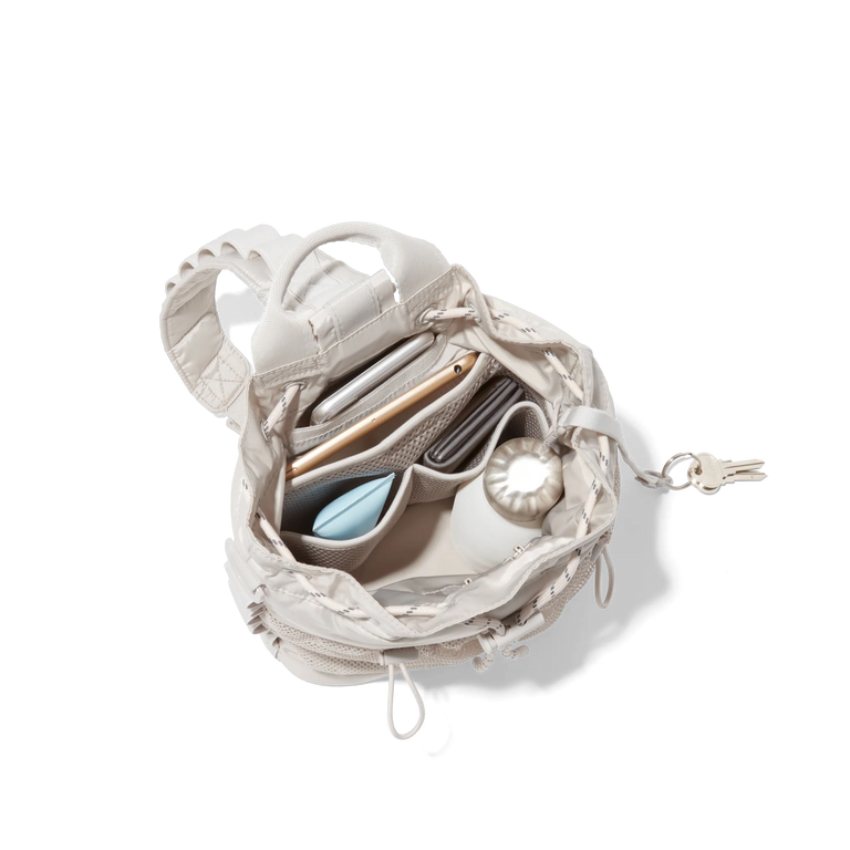 hover - Dagne Dover Nova Sling Bag in white opened, revealing the interior phone pocket and interior airmesh pockets.