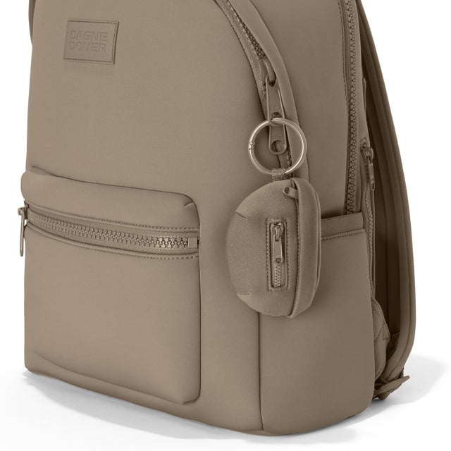 Dagne Dover Ace Keychain in a medium-dark, creamy tan clipped onto a backpack. hover