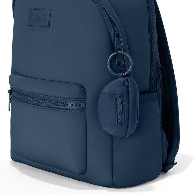 Dagne Dover Ace Keychain in a medium grey-blue with a touch of turquoise clipped onto a backpack. hover