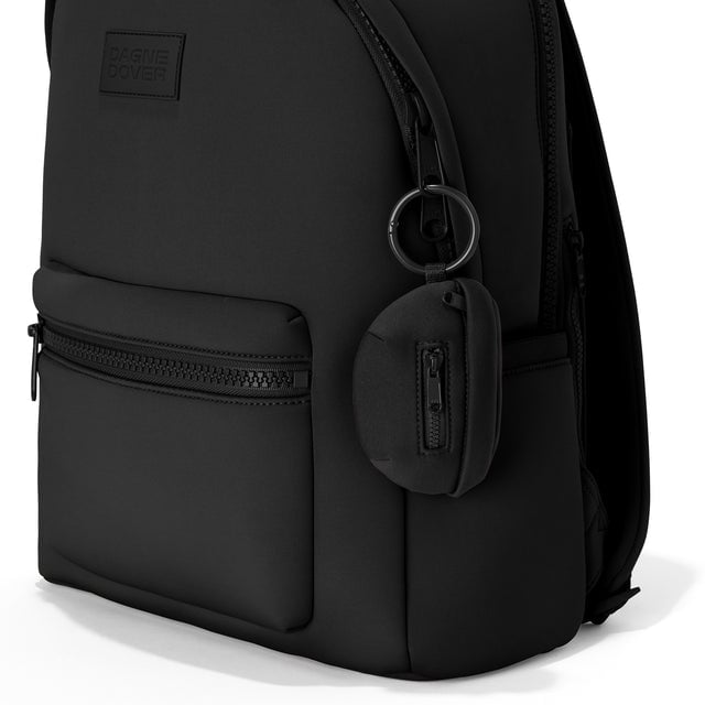 Dagne Dover Ace Keychain in black clipped onto a backpack. hover