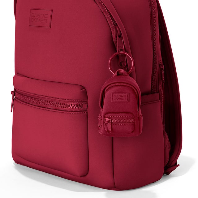 Dagne Dover Dakota Keychain in a punchy, saturated deep red clipped onto a backpack. hover