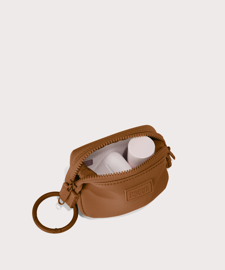Hunter keychain in a saturated, warm medium-brown with burnt orange undertones. unzipped, top down view. 
