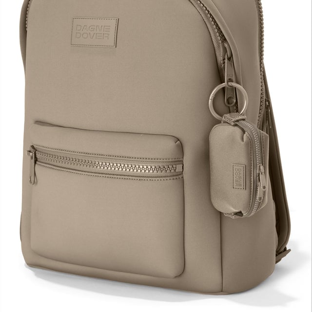 Dagne Dover Hunter Keychain in a medium-dark, creamy tan clipped onto a backpack. hover
