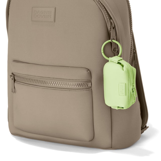 Dagne Dover Hunter Keychain in a vibrant, creamy green clipped onto a backpack. hover
