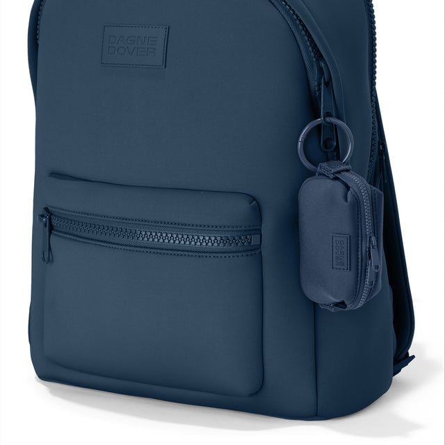 Dagne Dover Hunter Keychain in a medium grey-blue with a touch of turquoise clipped onto a backpack. hover