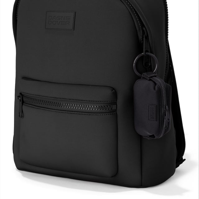 Dagne Dover Hunter Keychain in black clipped onto a backpack. hover