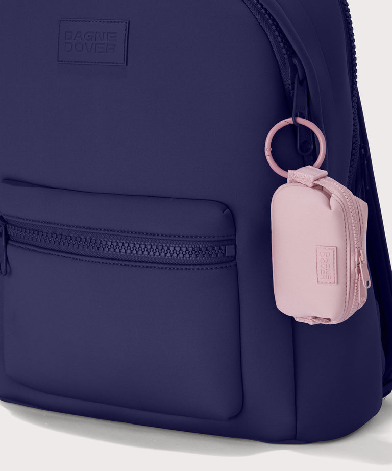 Hunter keychain in a cool, powdery pink with soft grey undertones.  side angle view.  front view showing keychain on dakota backpack. 
