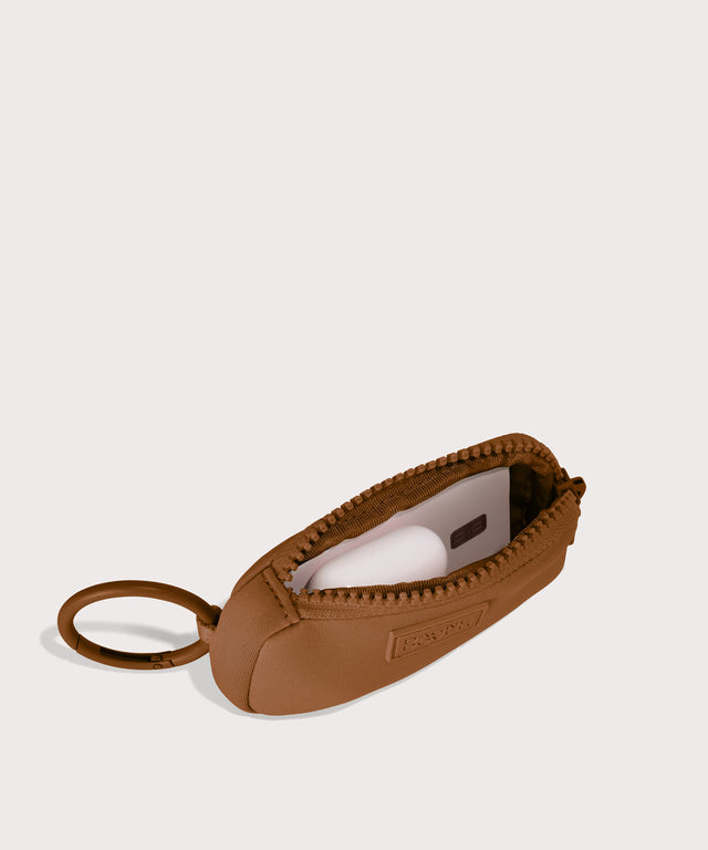 Mara Keychain in a saturated, warm medium-brown with burnt orange undertones . unzipped, top down view. 
