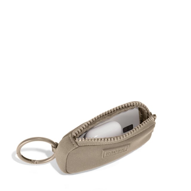Dagne Dover Mara Keychain in a medium-dark, creamy tan unzipped, showing interior.
